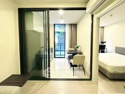 Modern apartment with open layout, featuring a cozy living area and a stylish bedroom.