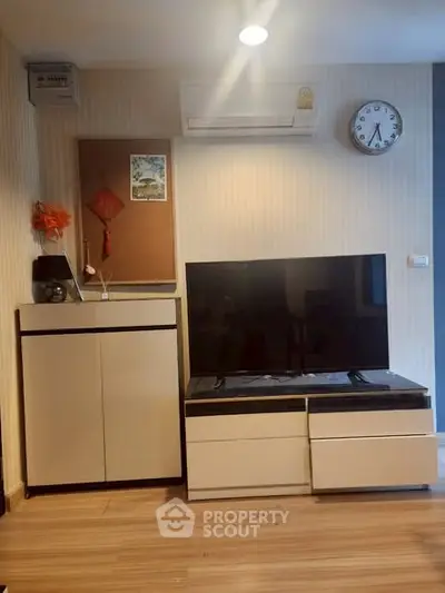 Modern living room with sleek TV stand and air conditioning, perfect for cozy entertainment.