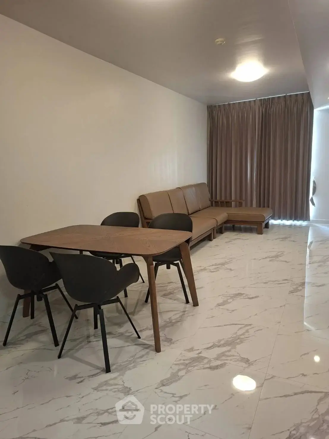 Modern living room with marble flooring and stylish furniture in a spacious apartment.