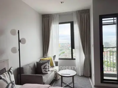 Modern living room with city view, stylish decor, and natural light
