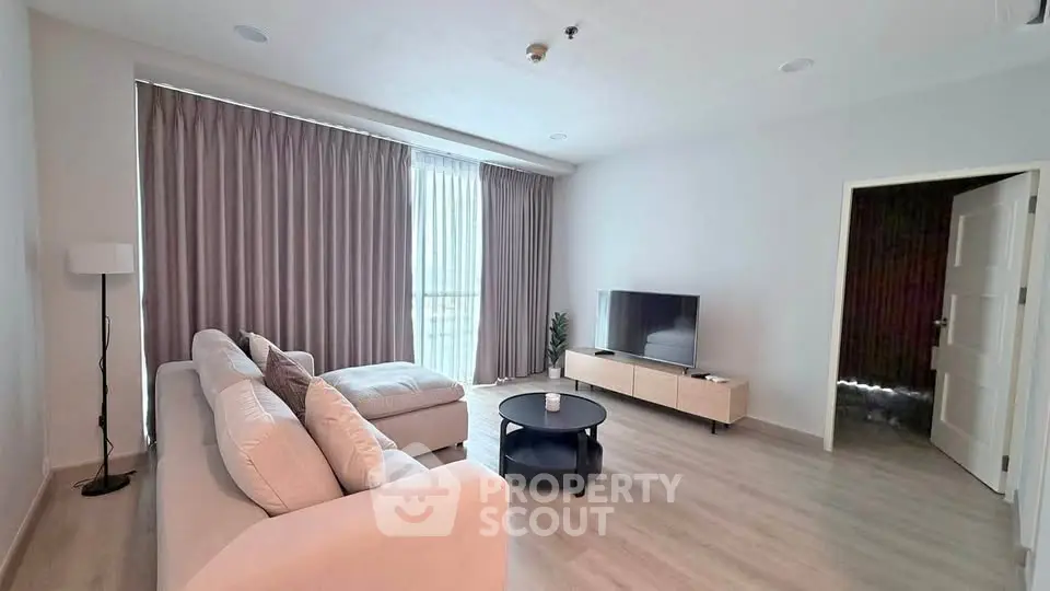Spacious modern living room with large windows and elegant decor