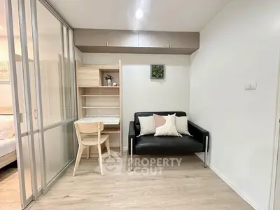 Modern study area with sleek desk, chair, and cozy sofa in stylish apartment