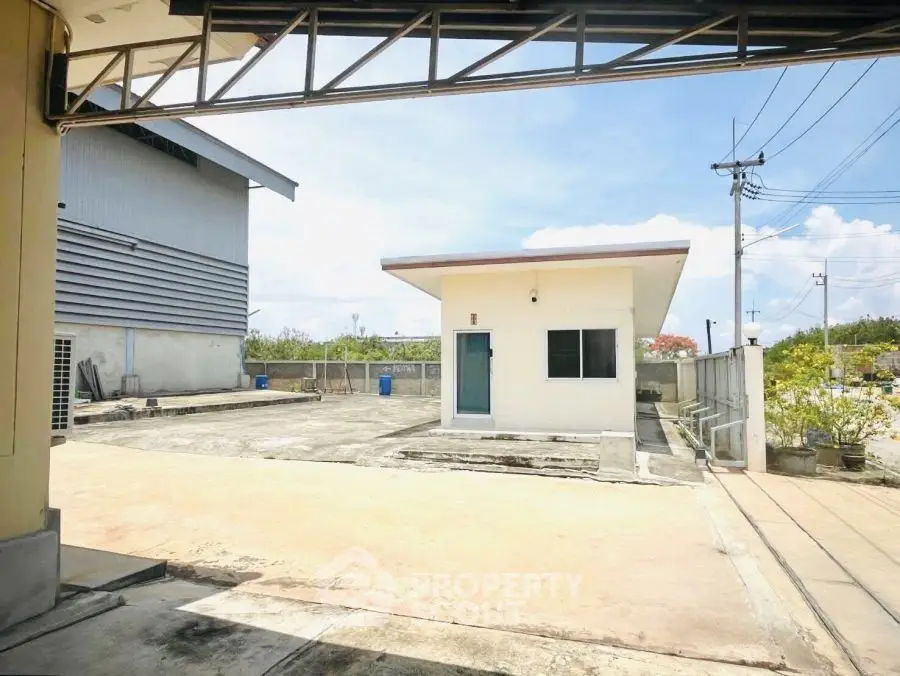 Spacious industrial property with open yard and utility building, ideal for business operations.
