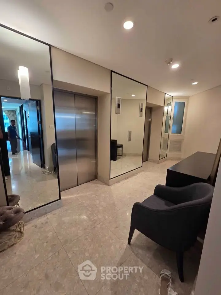 Modern building lobby with sleek elevators and stylish seating area