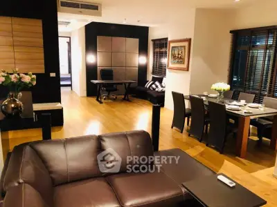 Luxurious open-plan living and dining area with elegant furnishings and modern decor.