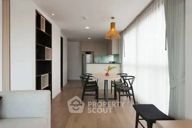 Modern open-layout living room with dining area and stylish lighting