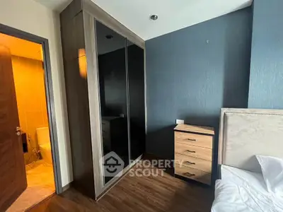 Modern bedroom with sleek wardrobe and wooden flooring