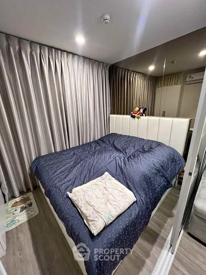 Cozy bedroom with elegant curtains and plush bedding in modern apartment