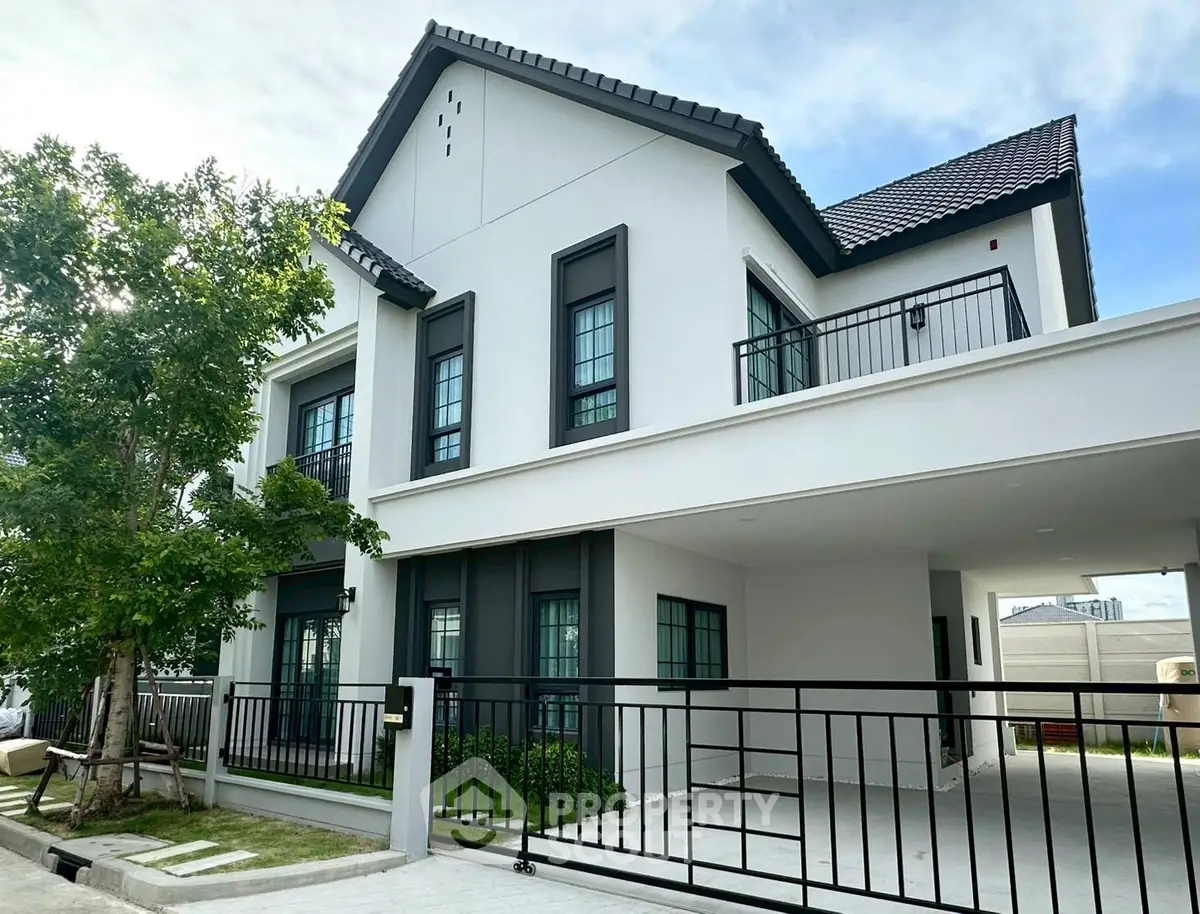 Elegant modern house with sleek design and spacious balcony in a serene neighborhood.