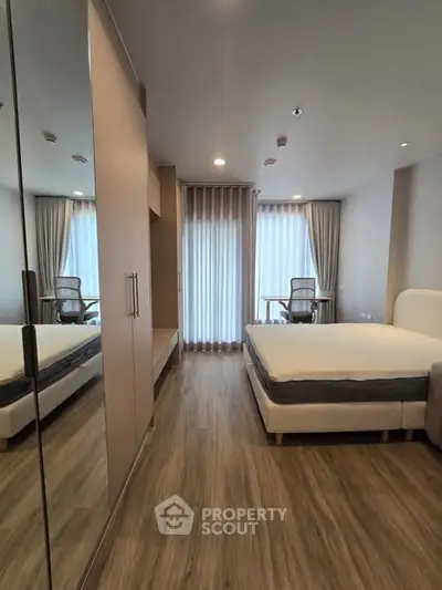 Modern bedroom with stylish decor and floor-to-ceiling windows