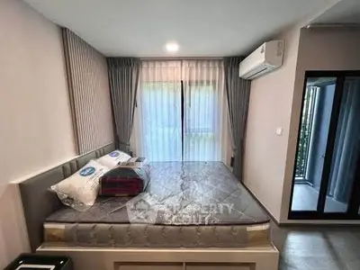 Modern bedroom with large window and air conditioning in stylish apartment