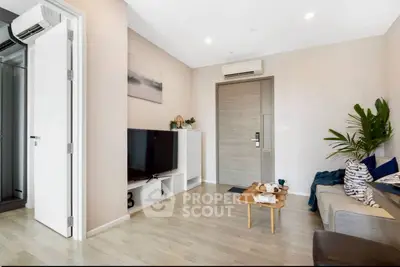 Modern living room with sleek design, featuring a cozy sofa, stylish coffee table, and wall-mounted TV.