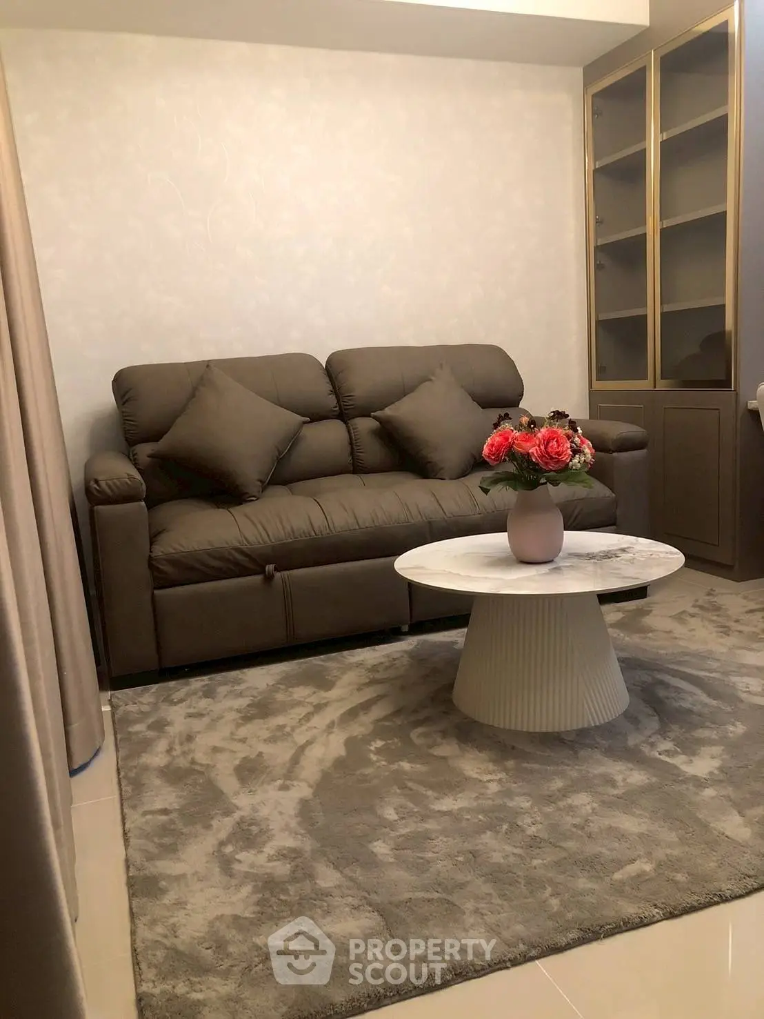 Cozy living room with plush sofa and elegant coffee table, perfect for relaxation and entertaining.