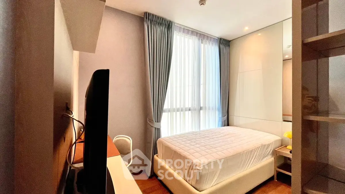 Cozy modern bedroom with large window and stylish decor