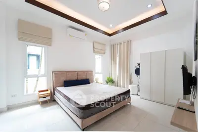 Spacious modern bedroom with elegant decor and natural light