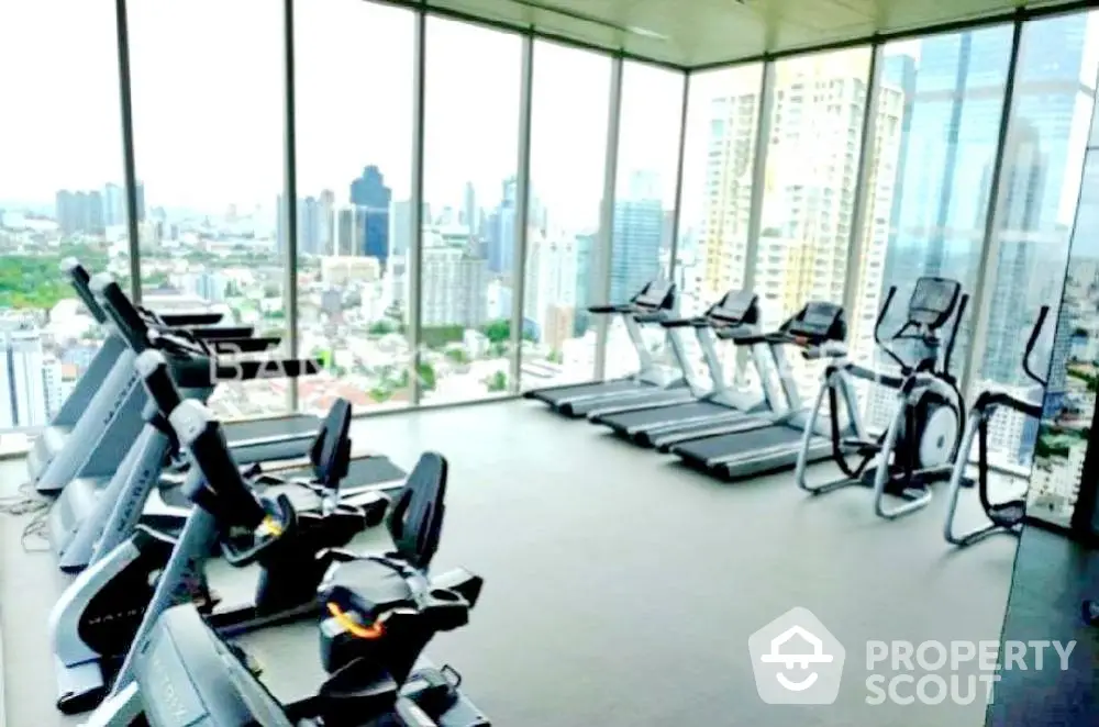 Luxury high-rise gym with panoramic city views and modern fitness equipment