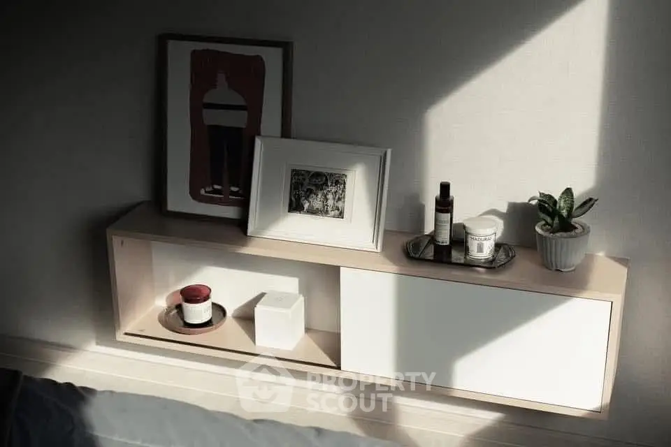 Stylish minimalist interior shelf with decor and plants, perfect for modern living spaces.