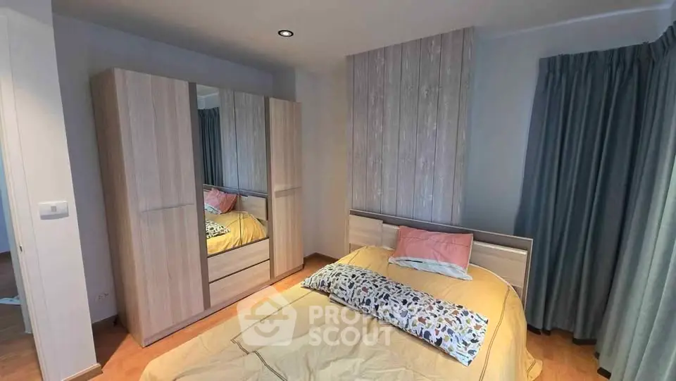Cozy bedroom with modern wooden wardrobe and stylish decor