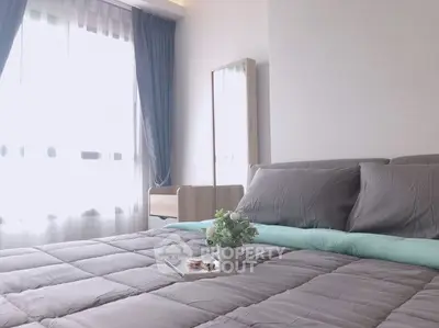 Cozy bedroom with elegant decor and natural light, perfect for relaxation.