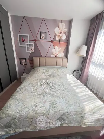 Charming bedroom with floral accent wall and natural light