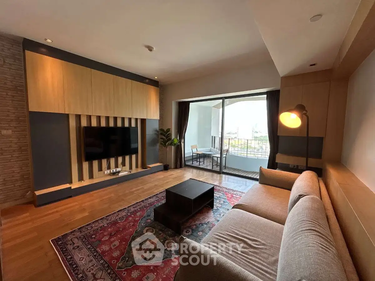 Spacious living room with modern decor and large balcony access.