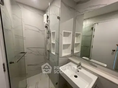 Modern bathroom with sleek glass shower and elegant marble tiles