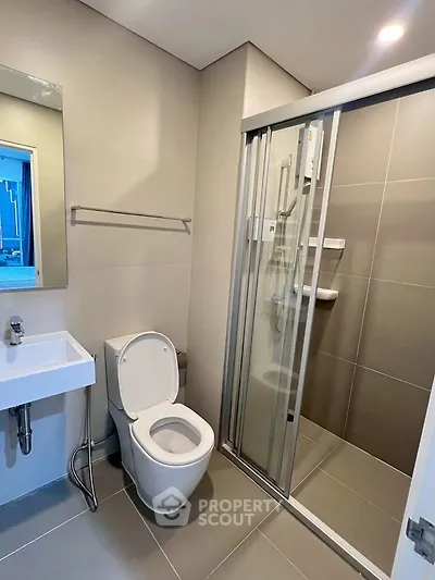 Modern bathroom with sleek shower enclosure and contemporary fixtures.