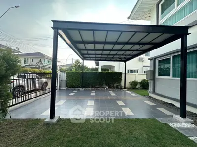 Modern home with spacious carport and tiled driveway in a serene neighborhood
