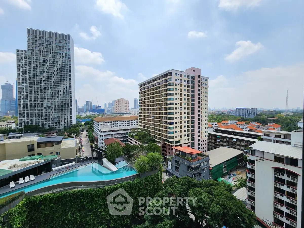 Stunning cityscape view with modern high-rise buildings and a rooftop pool, perfect for urban living.