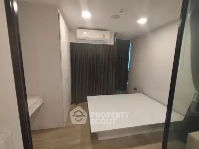 Modern minimalist bedroom with platform bed and air conditioning