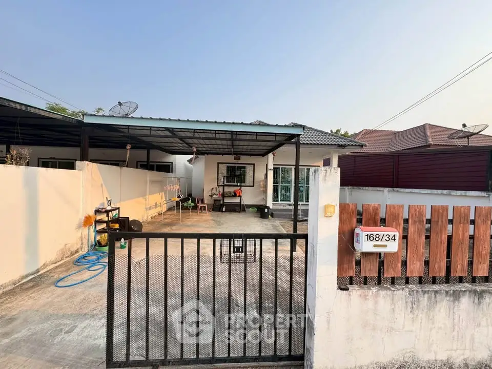 Charming single-story home with gated driveway and spacious front yard, perfect for family living.