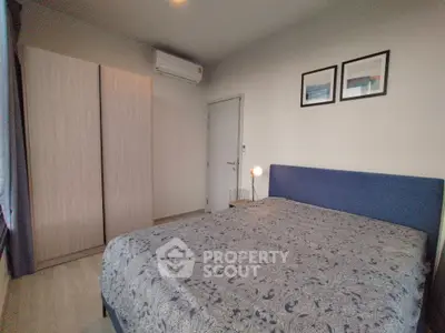 Cozy bedroom with stylish decor and ample natural light