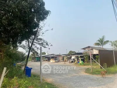 Spacious rural property with open land and rustic buildings, ideal for development or agriculture.