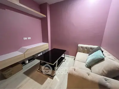 Cozy small living room with modern furniture and pink walls
