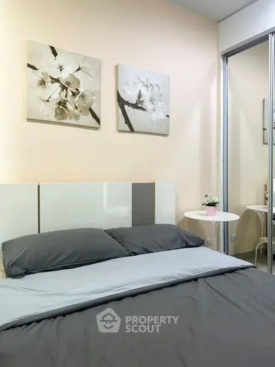 Cozy bedroom with modern decor and mirrored closet doors, perfect for relaxation.