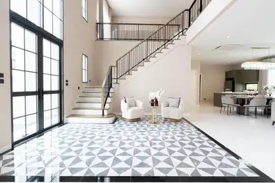 Luxurious modern living room with high ceilings and elegant staircase