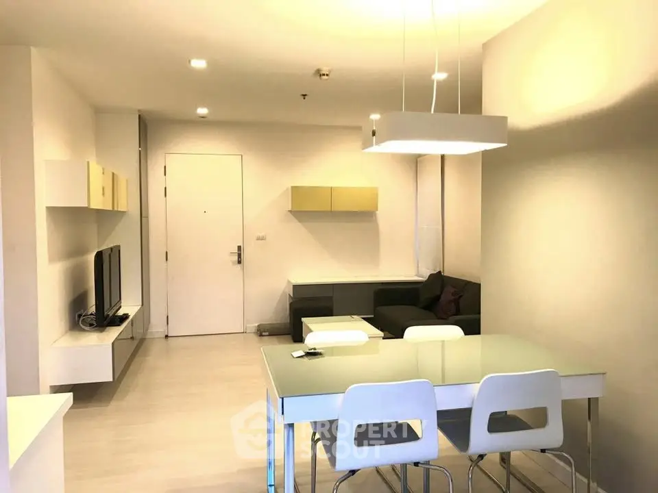 Modern living room with sleek furniture and ambient lighting in a stylish apartment.