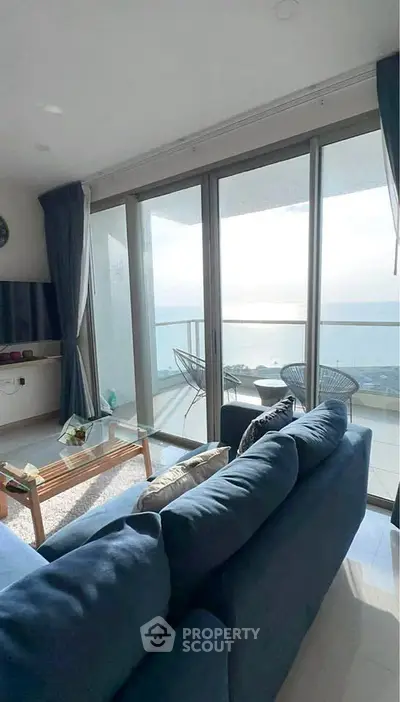 Stunning living room with ocean view and spacious balcony, perfect for relaxation and entertaining.