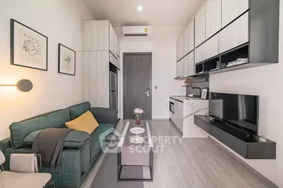 Modern living room with sleek furniture and wall-mounted TV in stylish apartment.