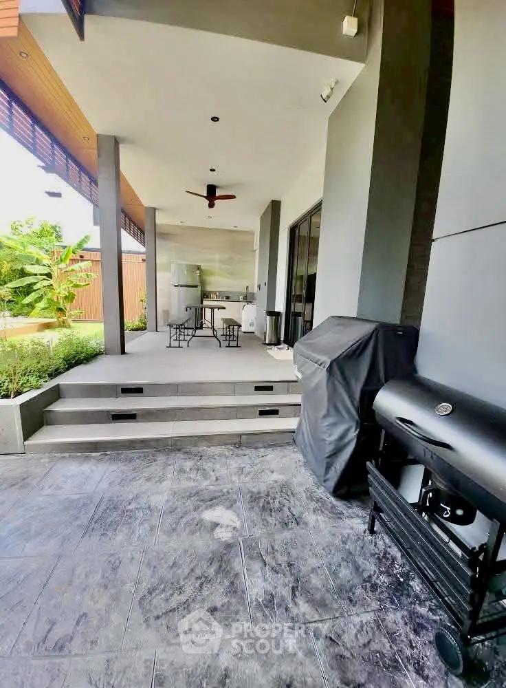 Modern outdoor BBQ area with sleek design and garden view