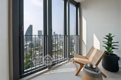 Stunning city view from modern balcony with stylish chair and potted plant.