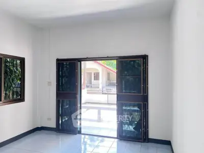 Bright room with large windows and outdoor view, perfect for natural light lovers.