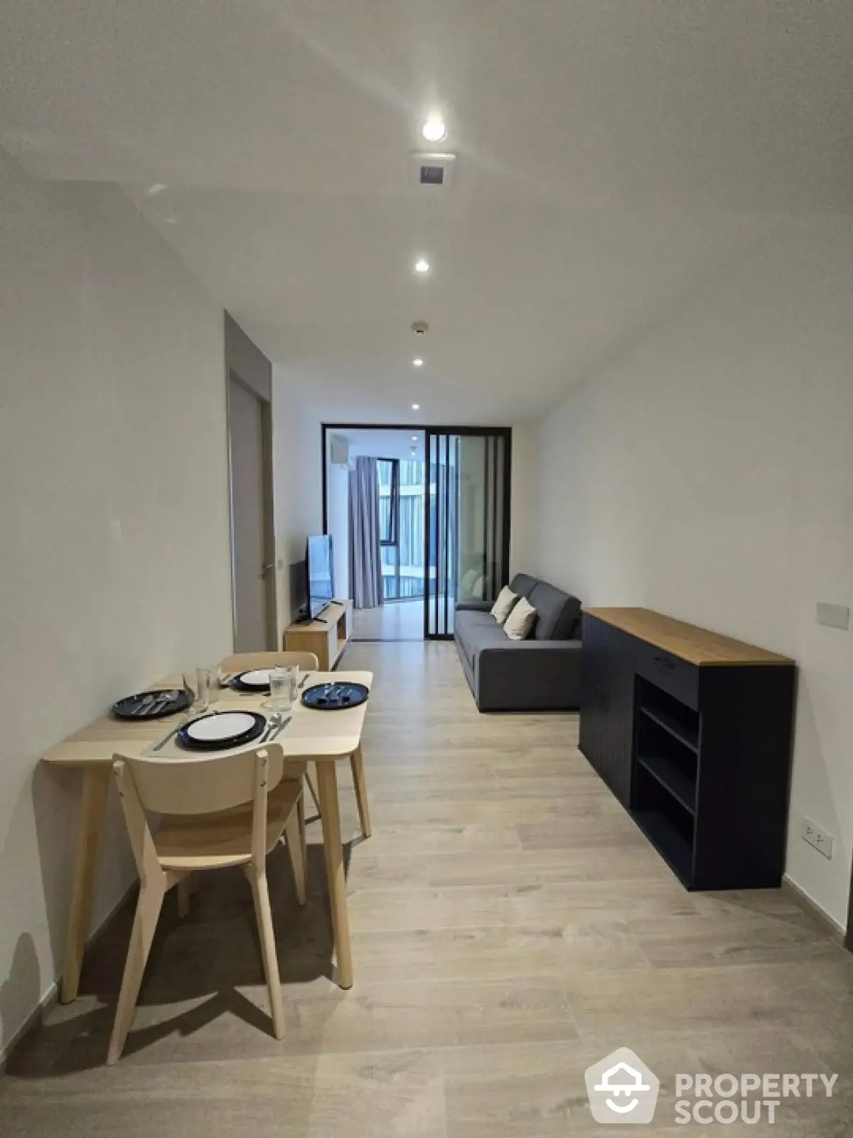 Modern living room with dining area and sleek furniture in a stylish apartment