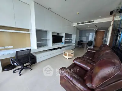 Spacious modern living room with leather sofa and built-in entertainment center