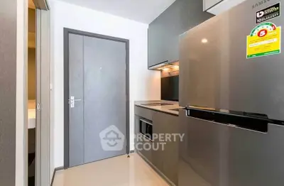 Modern compact kitchen with sleek appliances and minimalist design