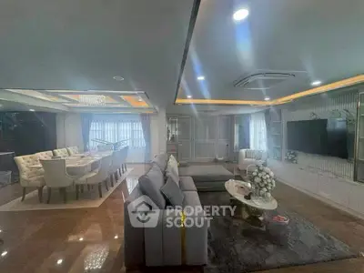 Luxurious open-plan living and dining area with elegant furnishings and ambient lighting.