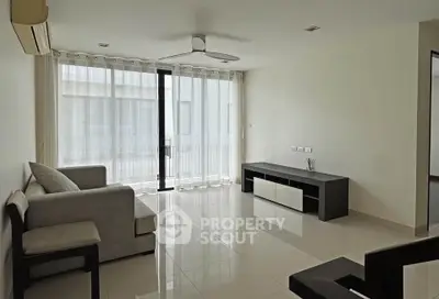 Spacious modern living room with large windows and minimalist furniture