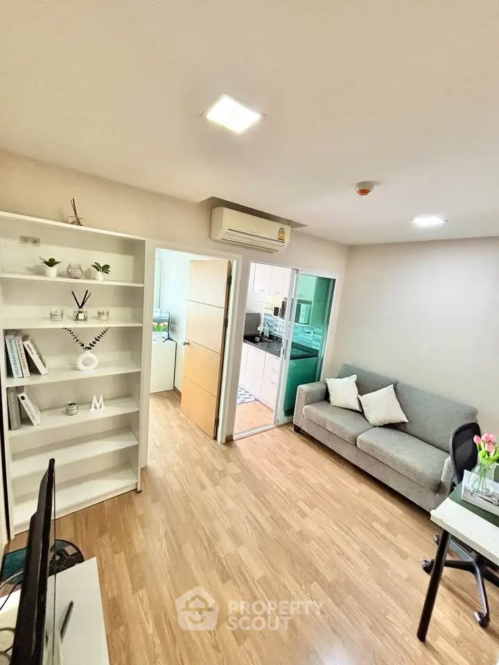 Modern living room with wooden flooring and cozy furniture in a stylish apartment.