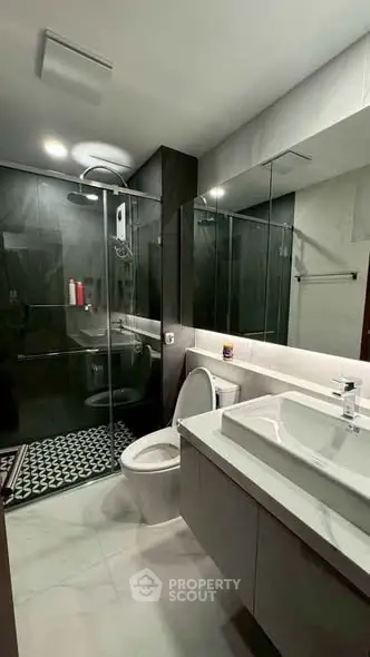 Modern bathroom with sleek design, glass shower, and elegant fixtures in a contemporary home.