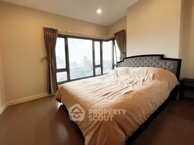 Spacious bedroom with panoramic city view and elegant decor